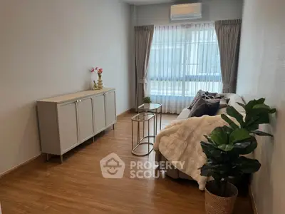 Stylish living room with cozy sofa, elegant decor, and natural light, perfect for relaxation.