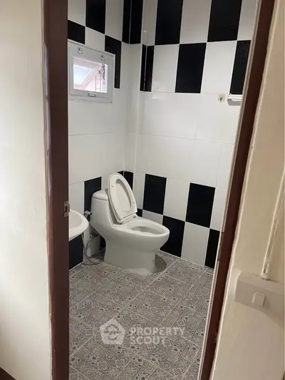 Modern bathroom with black and white tiles and stylish flooring