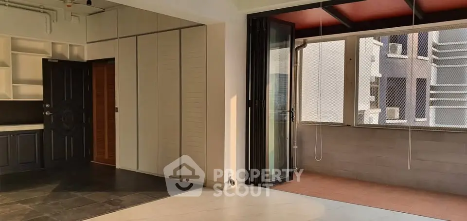 Spacious modern apartment with open layout and balcony access, featuring sleek finishes and ample natural light.