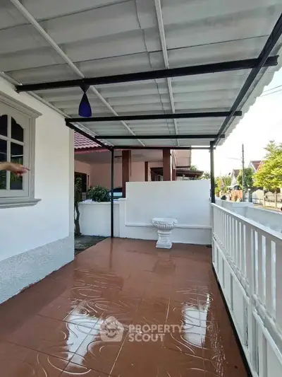 Charming covered patio with tiled flooring and decorative fountain, perfect for outdoor relaxation.