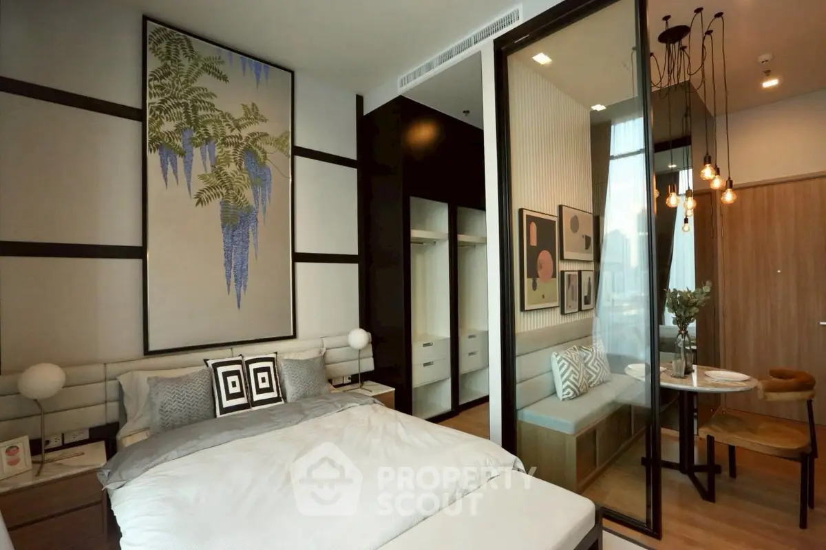 Modern bedroom with stylish decor and cozy dining nook in a contemporary apartment.