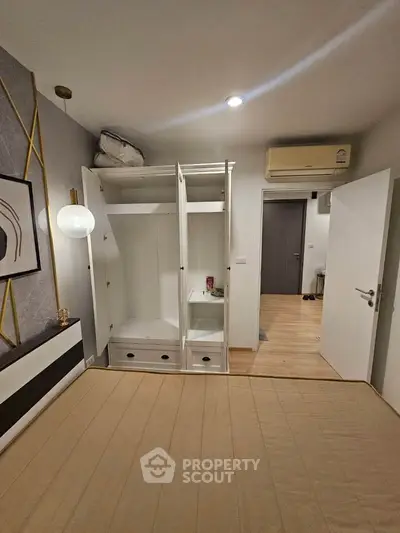 Modern bedroom with open wardrobe and stylish decor