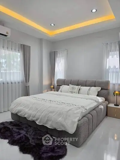 Luxurious modern bedroom with plush bed and ambient lighting