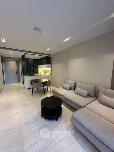 Modern living room with open kitchen layout and stylish furniture