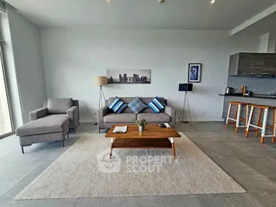 Modern living room with stylish furniture and open kitchen layout