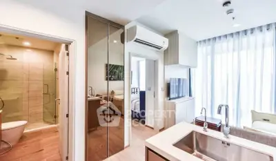 Modern apartment interior with open layout, featuring a sleek kitchen and bright living area.