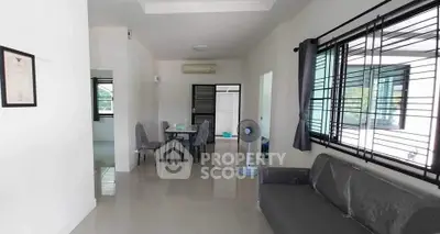 Modern living room with sleek furniture and large windows for natural light.