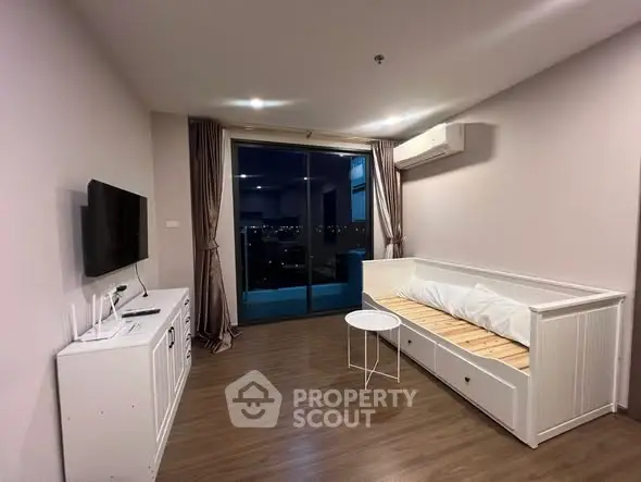 Modern living room with balcony view, featuring sleek furniture and ambient lighting.