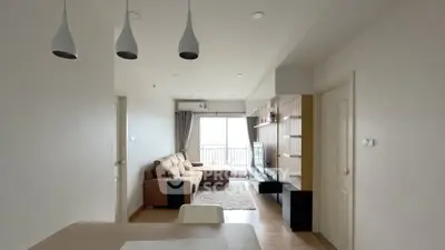 Modern living room with cozy sofa and TV, featuring elegant lighting and balcony view.
