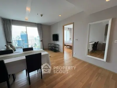 Spacious modern living room with wooden flooring and city view balcony