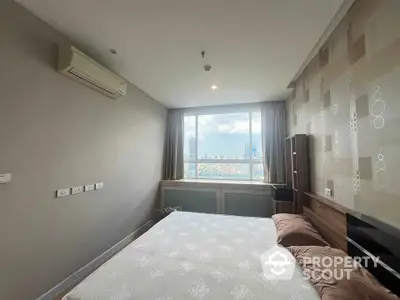 Modern bedroom with city view and air conditioning in high-rise apartment