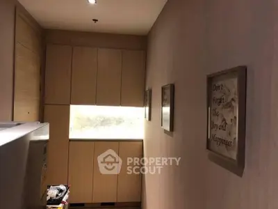 Cozy hallway with modern cabinetry and inspirational wall art in a stylish home.