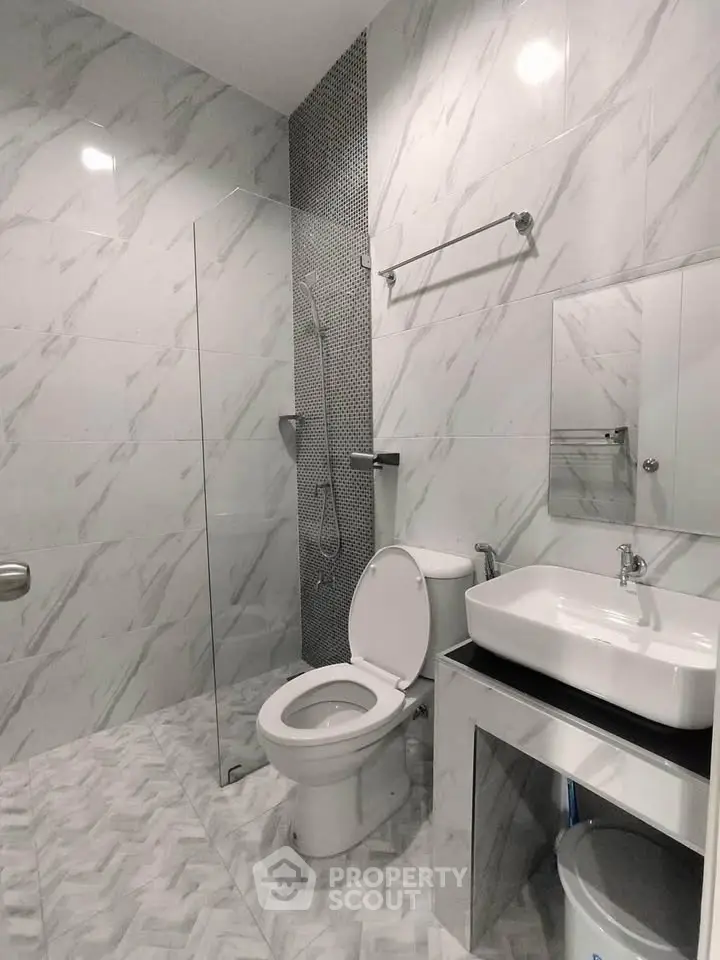 Modern bathroom with sleek design and glass shower partition