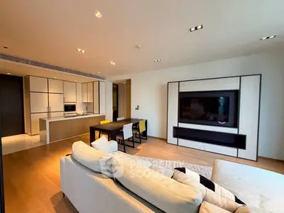 Modern open-plan living room with sleek kitchen and cozy seating area