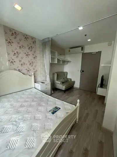 Charming bedroom with floral wallpaper and elegant furnishings in modern apartment.