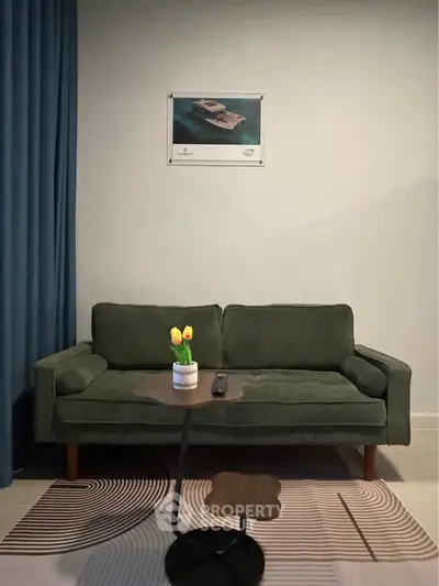 Stylish living room with green sofa and modern decor, perfect for relaxation.