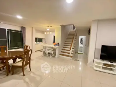 Spacious modern living room with open kitchen and elegant staircase
