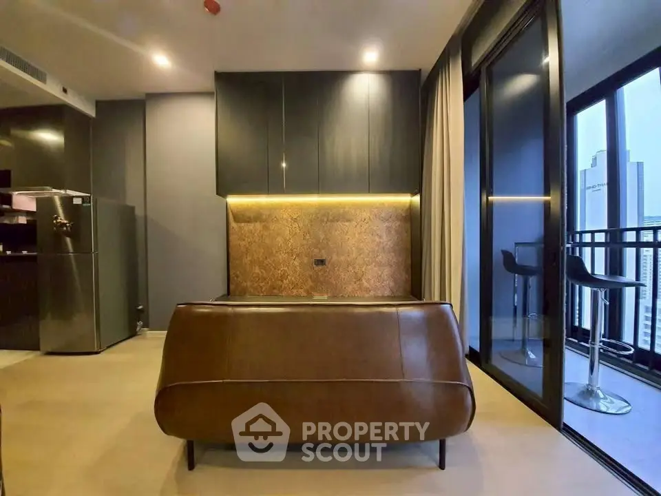 Modern living room with sleek furniture and balcony view in a high-rise apartment.