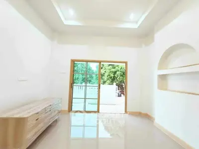 Spacious living room with sliding glass doors and built-in shelves