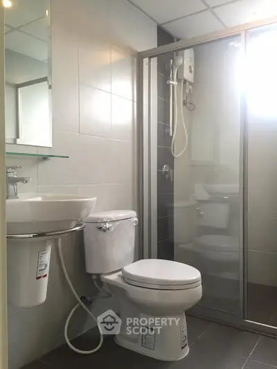 Modern bathroom with glass shower enclosure and sleek fixtures