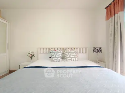 Cozy bedroom with stylish decor and natural light