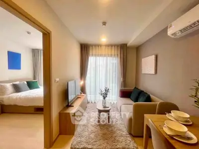 Modern living room with cozy decor and adjacent bedroom in stylish apartment.
