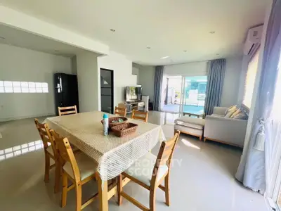 Spacious open-plan living and dining area with modern furnishings and natural light.