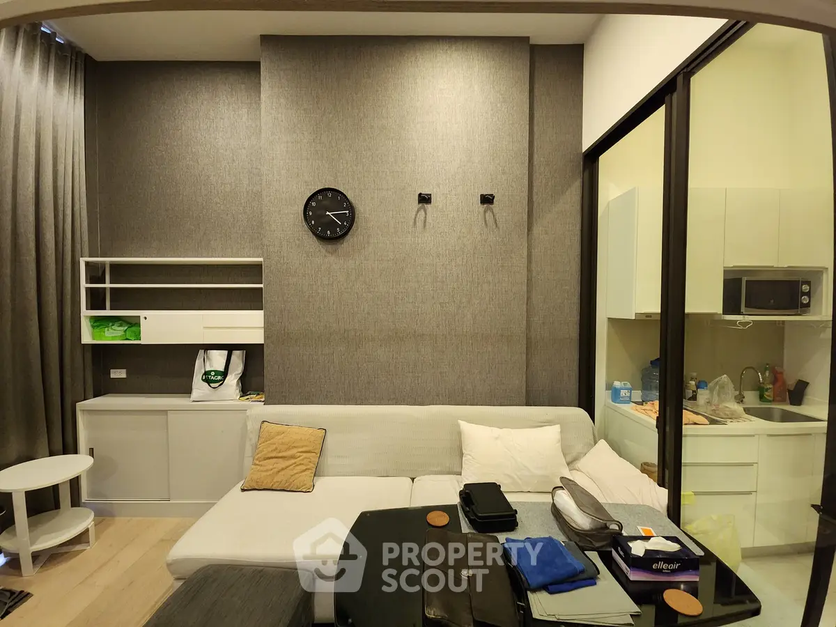 Modern living room with cozy sofa and open kitchen layout