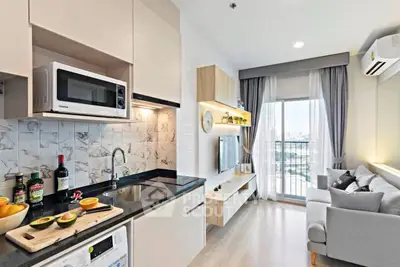 Modern open-layout kitchen and living room with balcony view