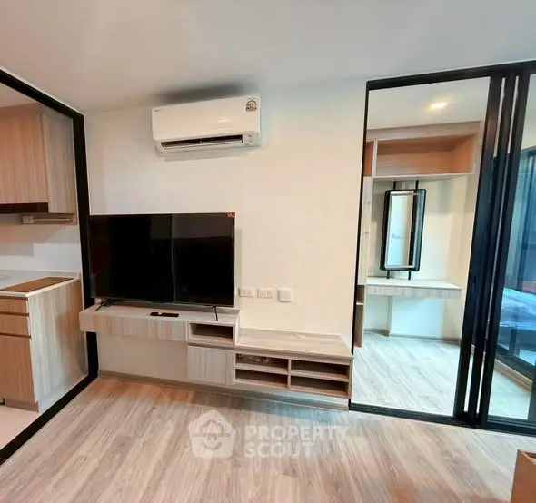 Modern living room with sleek design, featuring a mounted TV and air conditioning, perfect for urban living.