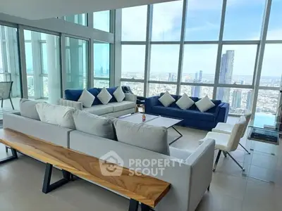 Luxurious high-rise living room with panoramic city views and modern furnishings.