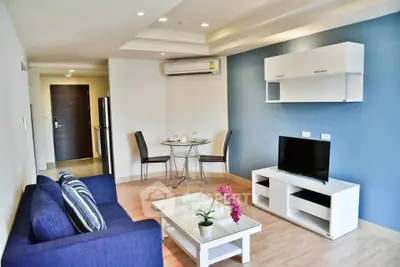 Modern living room with blue accent wall and sleek furniture