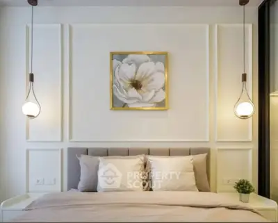 Elegant bedroom with modern lighting and floral artwork, perfect for relaxation.