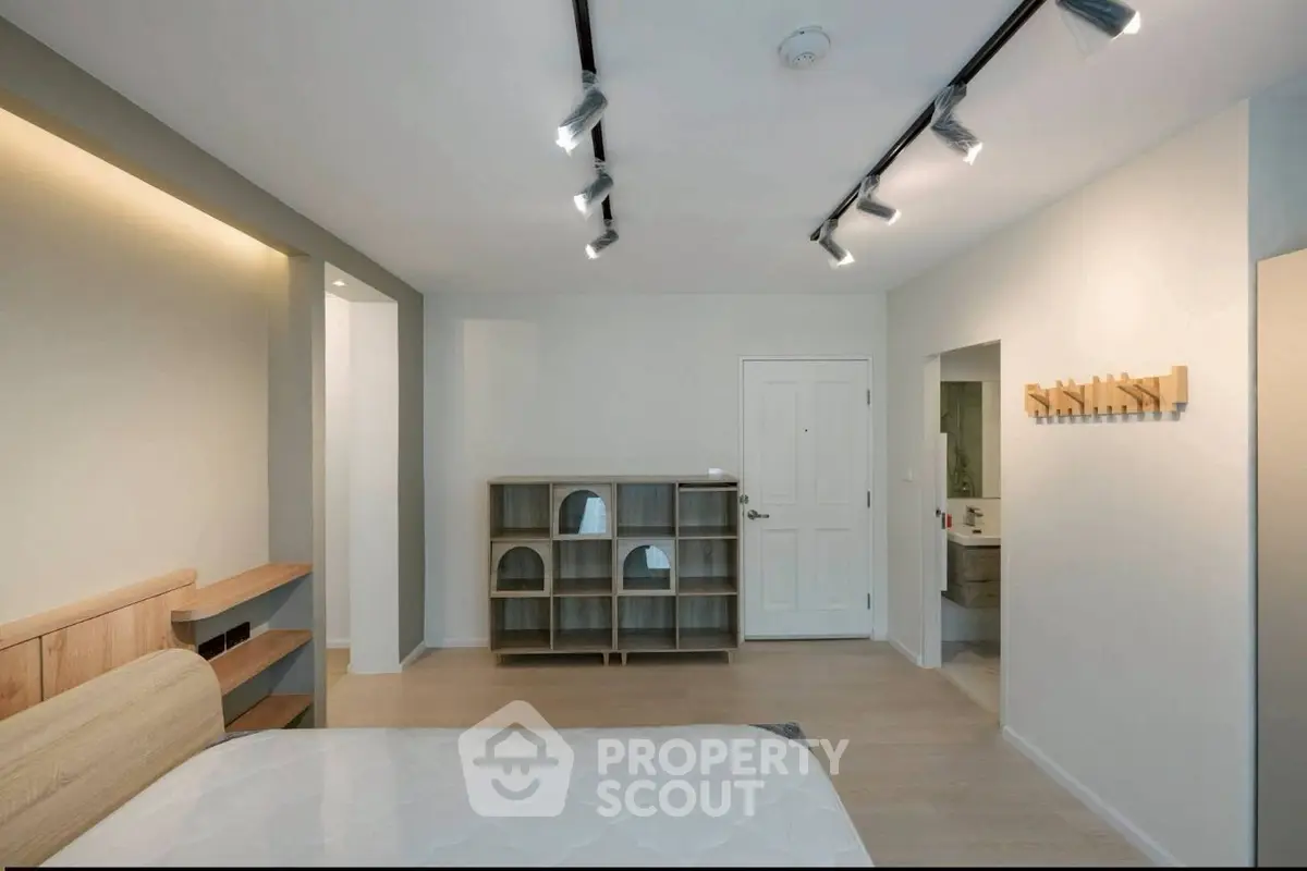 Modern bedroom with minimalist design and track lighting