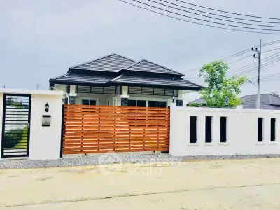 Modern single-story house with stylish fence and spacious driveway