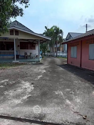 Charming suburban home with spacious driveway and lush greenery