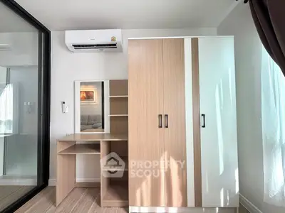 Modern bedroom with sleek wardrobe and air conditioning, perfect for comfortable living.