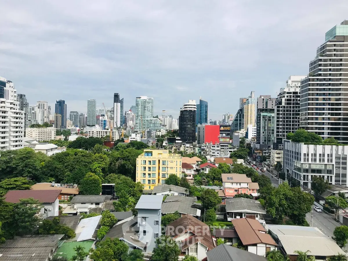 Stunning cityscape view showcasing urban skyline and lush greenery, perfect for real estate investment.