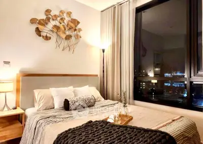 Cozy bedroom with city view, elegant decor, and ambient lighting