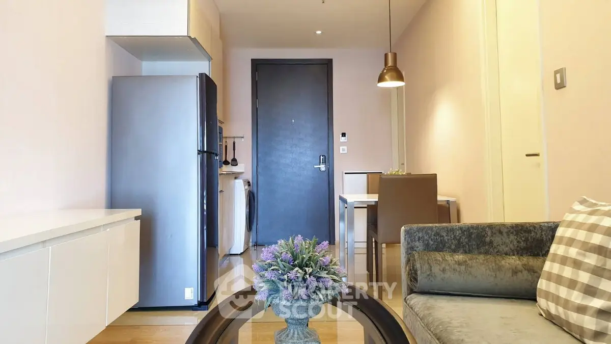 Modern apartment interior with sleek kitchen and cozy living area, featuring stylish furniture and elegant decor.