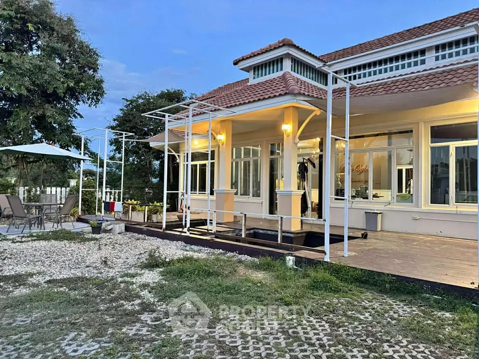 Charming suburban home with spacious patio and lush greenery, perfect for serene living.