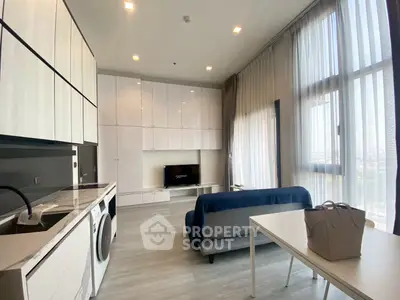 Modern living room with sleek furniture and large windows offering abundant natural light.