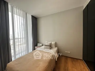 Cozy modern bedroom with single bed and large window view