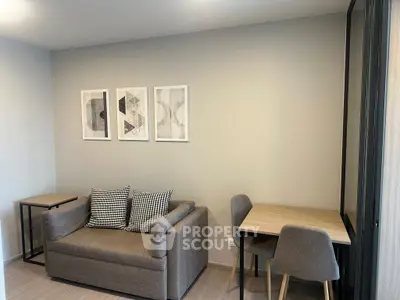 Modern living room with stylish sofa and dining area, perfect for cozy urban living.