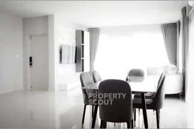 Modern dining area with sleek furniture and natural light in a stylish apartment.