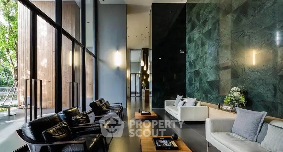 Luxurious modern living room with high ceilings and elegant decor, featuring floor-to-ceiling windows and stylish furniture.