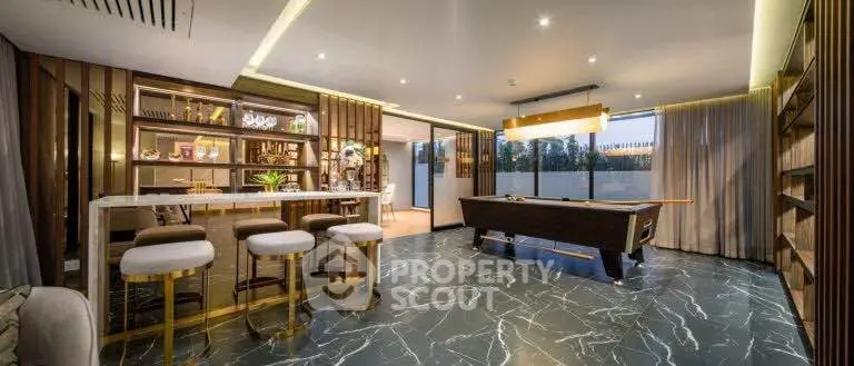 Luxurious living room with pool table and stylish bar area, perfect for entertainment.