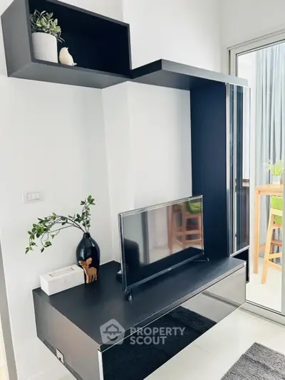 Modern living room with sleek black entertainment unit and stylish decor