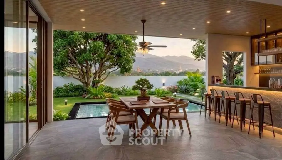 Luxurious open-air dining area with pool and stunning mountain view, perfect for entertaining and relaxation.