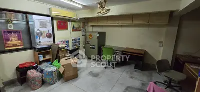 Spacious office room with storage cabinets and desks, ideal for small business setup.